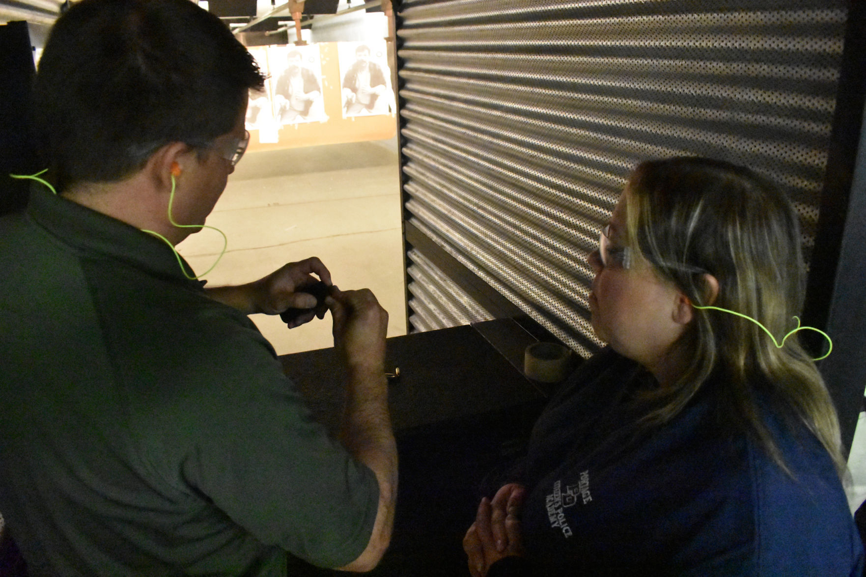 Klafke helps Marci Ward load a gun